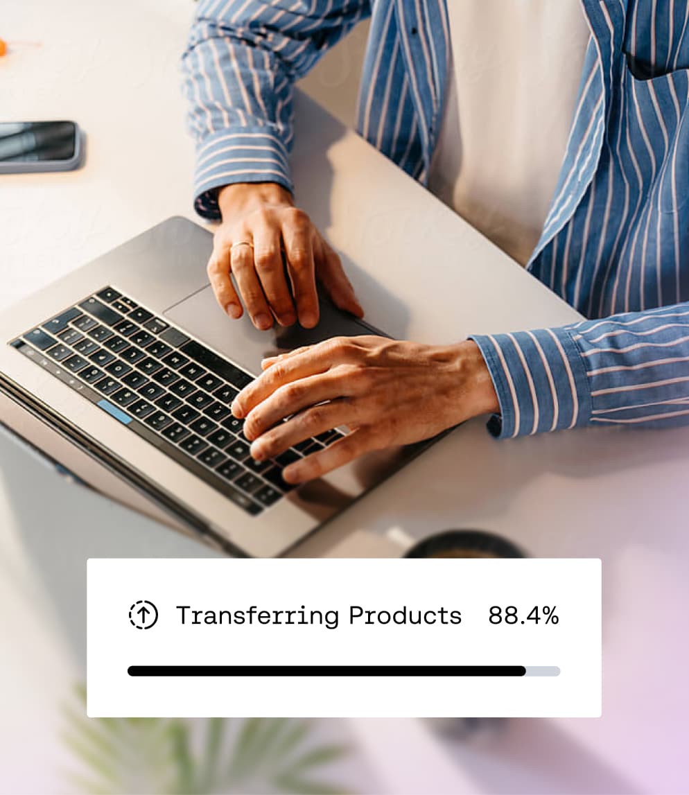 Person typing on a laptop with an overlay showing data migration progress for transferring products at 88.4%.